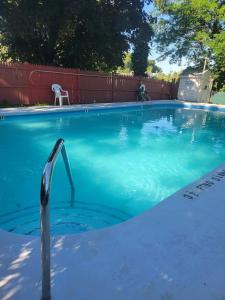 a swimming pool with blue water in a yard at Beautiful Space all for you! in New Britain