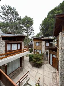 a group of buildings with trees in the background at Departamentos Amantea in Mar de las Pampas