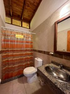 a bathroom with a toilet and a sink at Departamentos Amantea in Mar de las Pampas