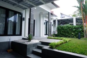 a house with stairs leading to the front yard at Blue Villa in Balikpapan