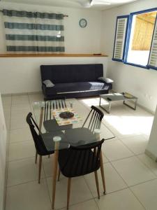 a living room with a table and chairs and a couch at Villa Campêche Azur in Le Marin