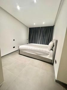 a bedroom with a bed and a window at Luxury Brand New Apartment in Brussels