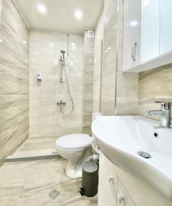 a bathroom with a toilet and a sink and a shower at Central Apartment for 4 Guests Next to State Opera in Stara Zagora