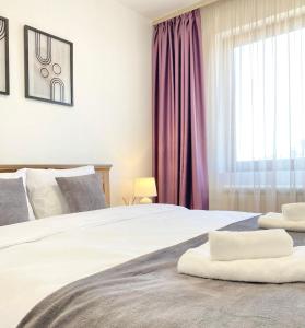 a bedroom with a large bed with purple curtains at Central Apartment for 4 Guests Next to State Opera in Stara Zagora