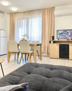 a living room with a table and a dining room at Central Apartment for 4 Guests Next to State Opera in Stara Zagora