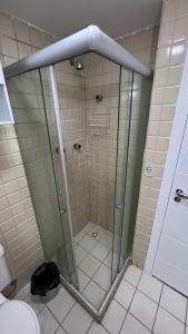 a shower with a glass door in a bathroom at Lindo vista mar na Praia do Buracão - Rio Vermelho in Salvador