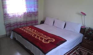 
A bed or beds in a room at Konkon Wonderland
