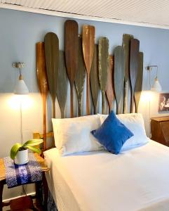 a bedroom with a bed with a bunch of surfboards on the wall at Orcas Hotel in Orcas
