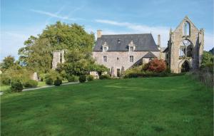 a large stone house with a large yard at Amazing Home In Quemper Guzennec With Kitchen in Quemper-Guézennec