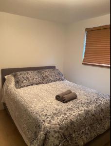 a bedroom with a bed with a pair of shoes on it at Heaven Is A Place On Earth in Montreal