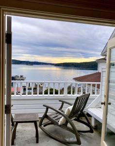 a porch with a chair and a bench and a view of the water at Orcas Hotel in Orcas