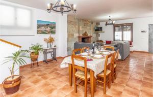 a dining room and living room with a table and chairs at Awesome Home In Caete La Real With 5 Bedrooms, Private Swimming Pool And Outdoor Swimming Pool in Cañete la Real