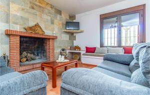 a living room with two couches and a fireplace at Awesome Home In Caete La Real With 5 Bedrooms, Private Swimming Pool And Outdoor Swimming Pool in Cañete la Real