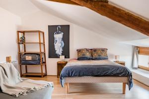 a bedroom with a bed in a attic at Gîte de la Chabespa, belle vue, au calme in Sigottier