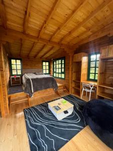 a bedroom with a bed and a desk in a room at Huitaca Glamping in Paipa