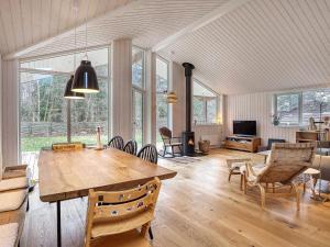 a living room with a wooden table and chairs at Holiday home Rørvig XVI in Rørvig