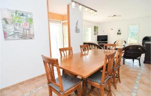 a dining room with a wooden table and chairs at Stunning Home In Molires-sur-cze With Wifi in Molières-sur-Cèze