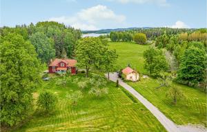 an aerial view of a house in a field at 4 Bedroom Stunning Home In Lngserud in Eldansnäs