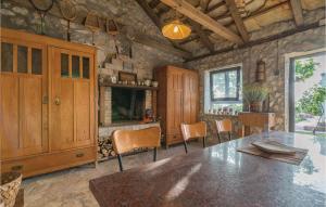 a dining room with a wooden table and chairs at 2 Bedroom Amazing Home In Krkovic in Lađevci