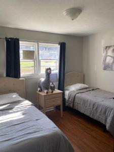 1 dormitorio con 2 camas y un animal de peluche sobre una mesa en Hiker's Retreat modern 3 bedroom home with 2 baths, en Travelers Rest