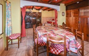 a dining room with a table and chairs at 3 Bedroom Gorgeous Home In Intres in Saint-Agrève +13 photos