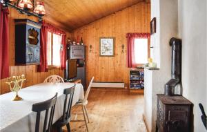 a dining room with a table and chairs and wooden walls at Nice Home In Noresund With 5 Bedrooms And Sauna in Noresund