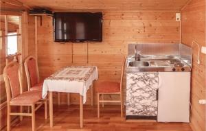a small kitchen with a table and a stove at Awesome Home In Deutschlandsberg With 1 Bedrooms And Wifi in Schwag