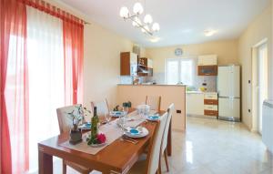 a kitchen and dining room with a table and chairs at Cozy Home In Nedescina With Kitchen in Nedeščina
