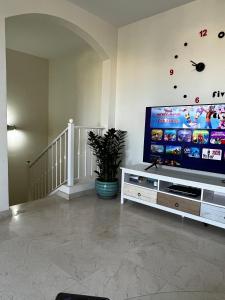 a living room with a large flat screen tv at Elegant Palm Mar Apartment in Palm-Mar