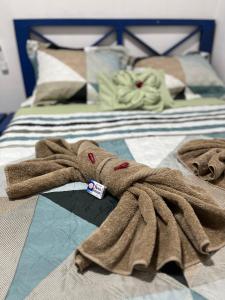 a brown towel laying on top of a bed at Hostal Camping La Y Griega in Bocas del Toro
