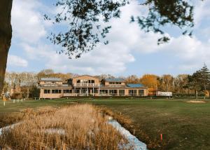 a large building sitting on top of a field at Messingham Lakes in Messingham