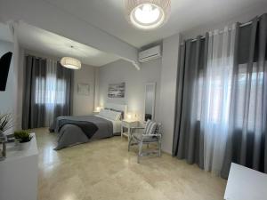 una camera da letto con un letto e un tavolo con una sedia di Villa TRIANA con piscina a Siviglia Altre 44 foto