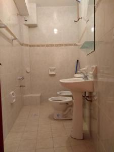 a bathroom with a sink and a toilet and a shower at HOSTAL DOÑA BERTA in Humahuaca