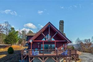 a log cabin with a large deck in front of it at Luxury Mountain Cabin Retreat w/ Stunning Views in Bostic