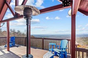 a porch with chairs and a street light on a deck at Luxury Mountain Cabin Retreat w/ Stunning Views in Bostic