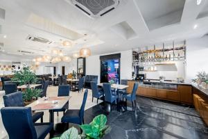 a restaurant with tables and chairs and a bar at HAKO HOTEL JBCC in Johor Bahru