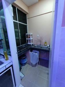 a kitchen with a sink and a counter top at HS Homestay in Sandakan