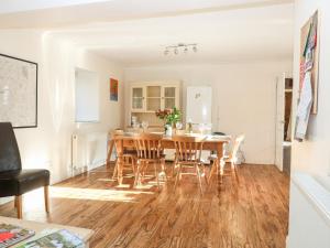 a dining room with a wooden table and chairs at Stone Wheel Cottage in Hook Norton