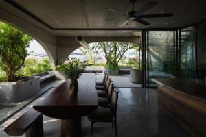 a dining room with a table and chairs and a ceiling fan at Hoa house in Ho Chi Minh City