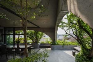 a building with a patio with a table and chairs at Hoa house in Ho Chi Minh City