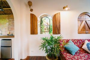 a living room with a couch and a window at Hygge Siargao in General Luna