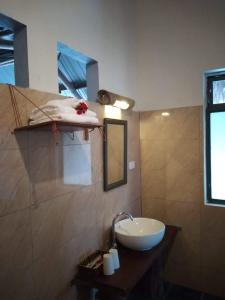 a bathroom with a sink and a mirror at Mai Chau Green house in Mai Châu