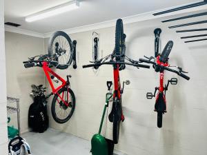 a group of bikes hanging on a wall at Snowcreek 2 Alpine Chalet, Private Garage in Thredbo