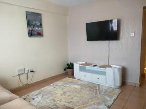 A television and/or entertainment centre at Amazing 1 Bedroom Apartment, Juja