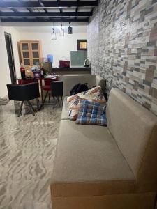 ein Sofa in einem Zimmer mit Ziegelwand in der Unterkunft Rochelle Mendoza 