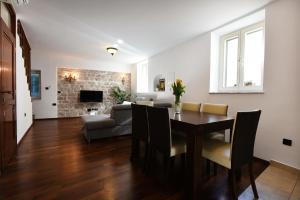 a living room with a dining room table and a couch at Apartment Kokolo in Šibenik