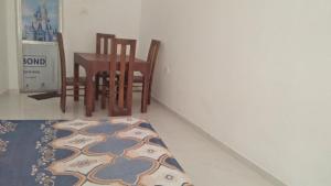 a room with a table and chairs and a rug at Ocean Dream in Tangalle