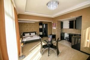 a bedroom with a bed and a table in a room at Panorama 360° Hotel in Tbilisi City