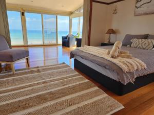 a bedroom with a bed with a teddy bear on it at Sandy Shores Estate- Long Island in Frankston
