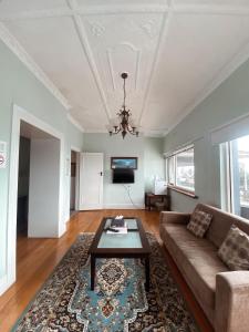 a living room with a couch and a table at Stella's Dromana Hotel in Dromana